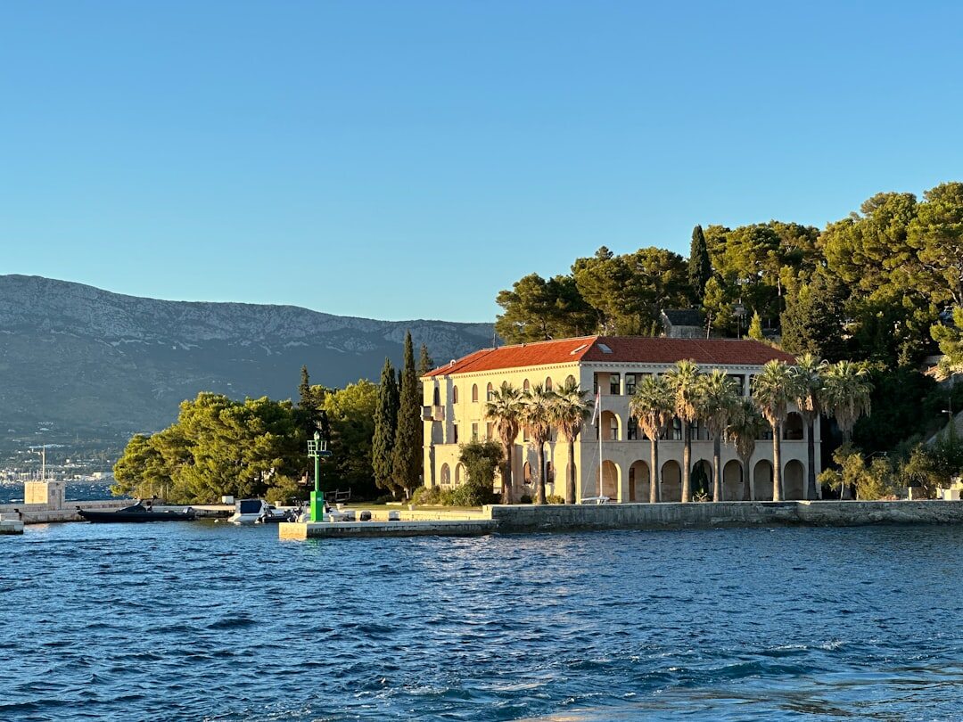 Old stone mansion covered in ivy on the Adriatic coast at dusk