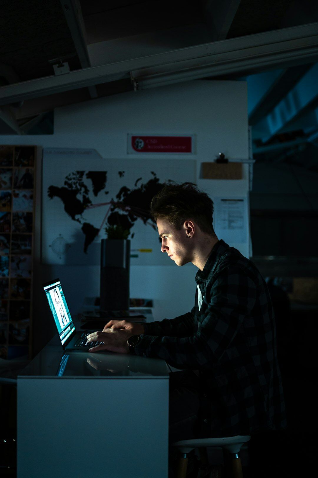 writer typing on laptop at night
